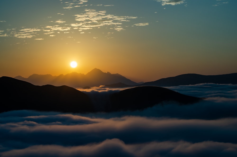 silhouette of mountains under blue sky during daytime