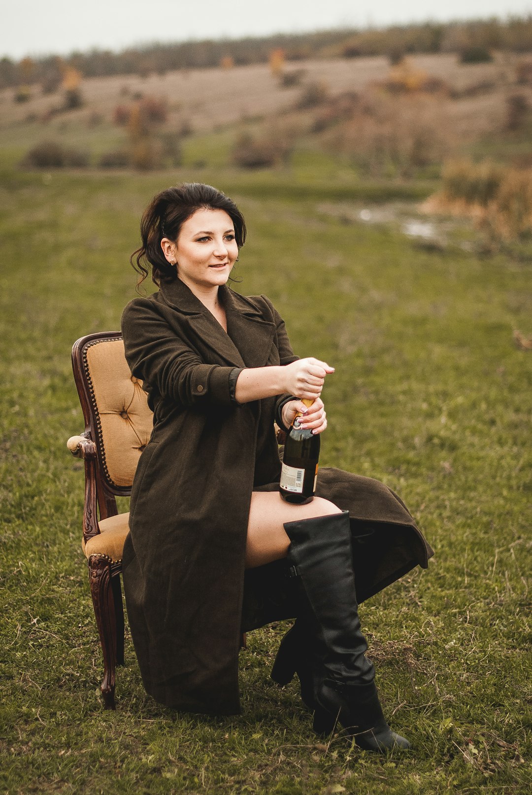 woman in brown coat sitting on brown wooden chair