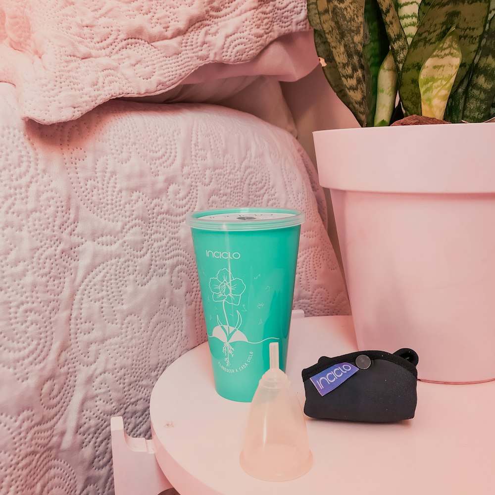 pink and white plastic cup on white table