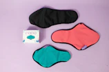 Flat lay of Kixtia menstrual underwear in black deep and pastel pink tones on a minimalist background.