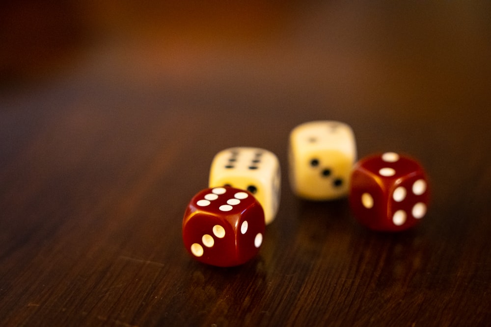 seven white and red dices on brown wooden table