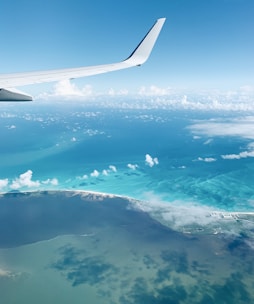 airplane wing over clouds during daytime