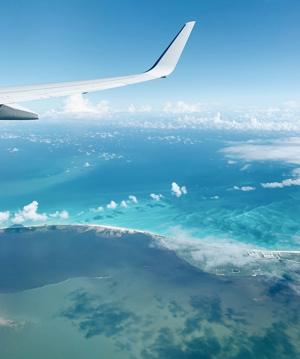 airplane wing over clouds during daytime