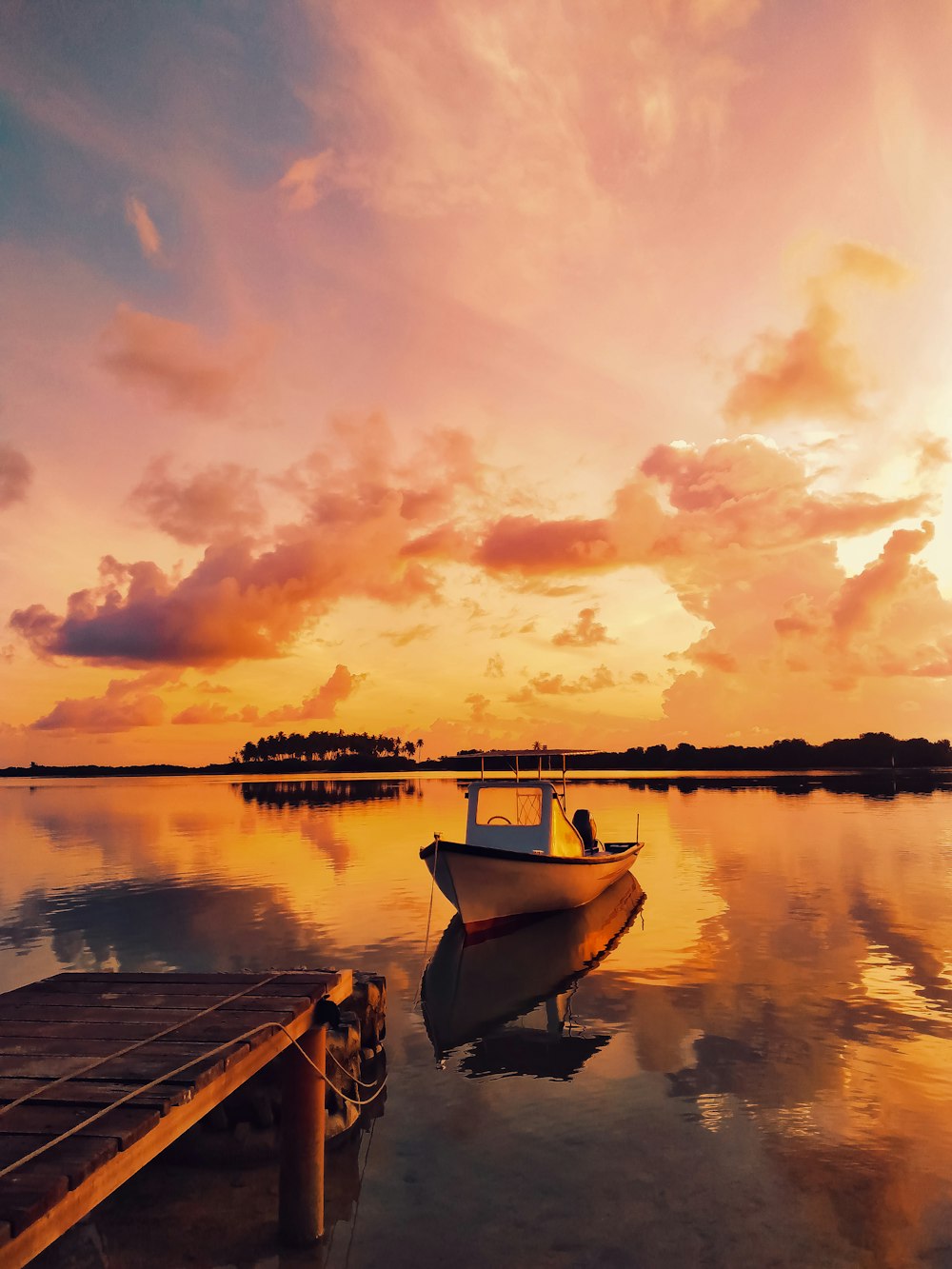 white boat on dock during sunset