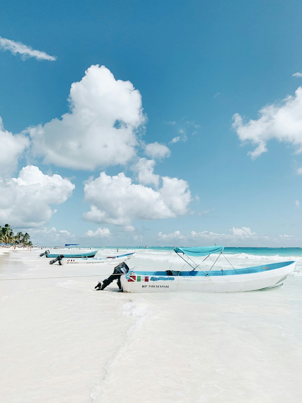 people walking on white sand beach during daytime