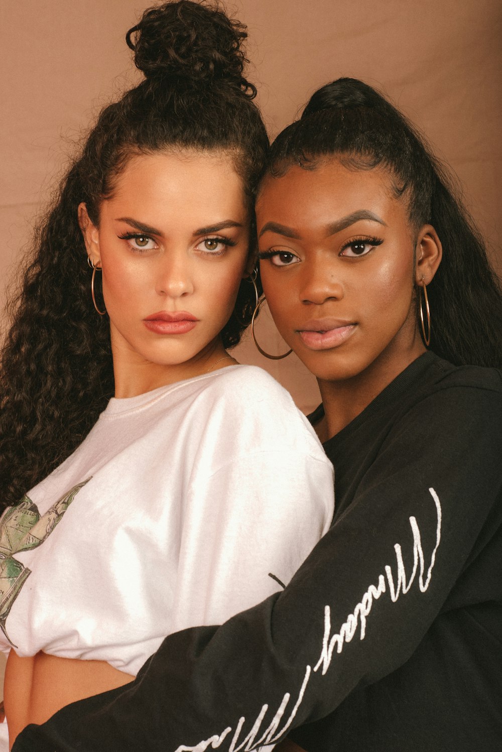 woman in white shirt beside woman in black shirt