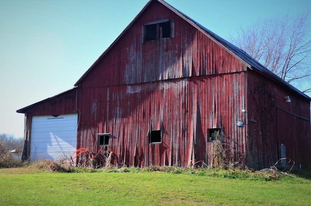 brown wooden barn house on green grass field during daytime