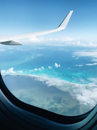 airplane window view of clouds during daytime
