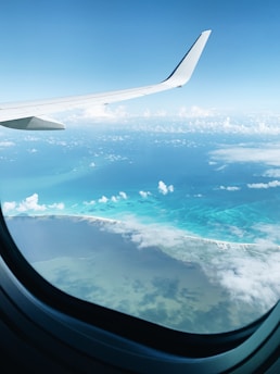 airplane window view of clouds during daytime