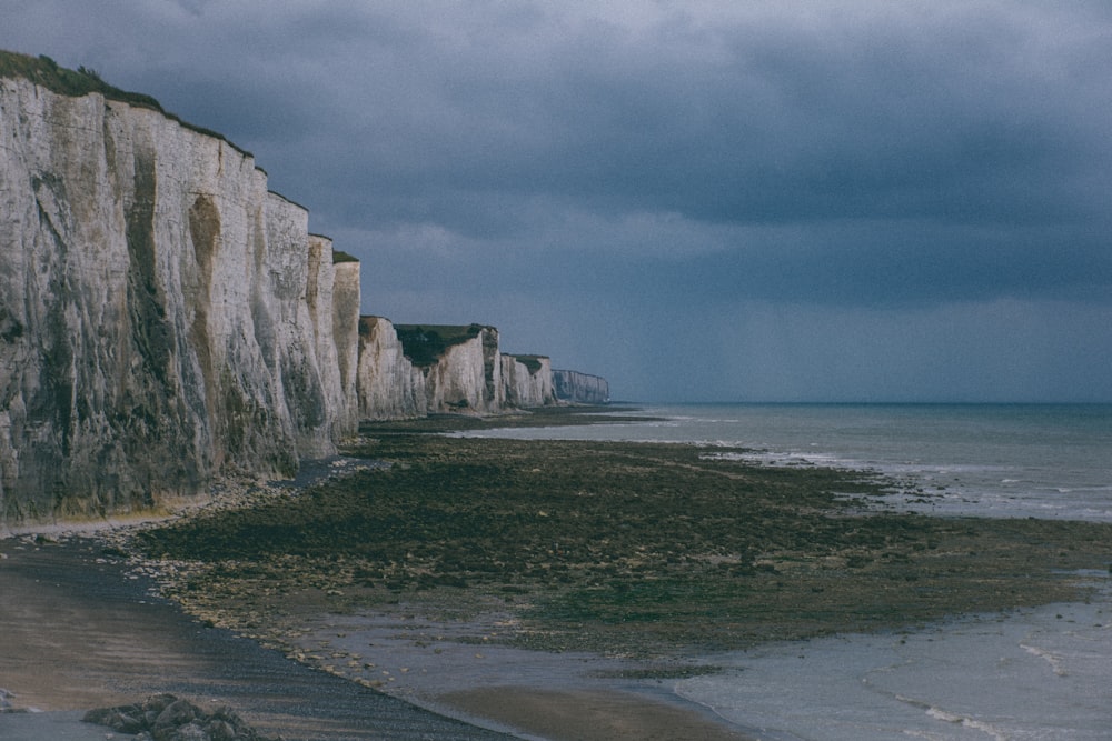 gray rock formation near sea during daytime