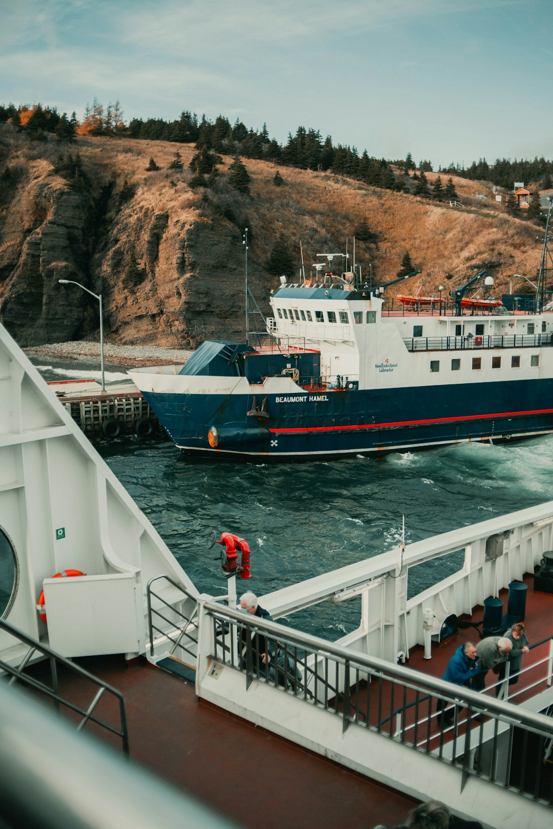 people on white and red ship on sea during daytime