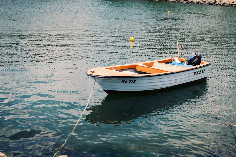 white and brown boat on body of water during daytime