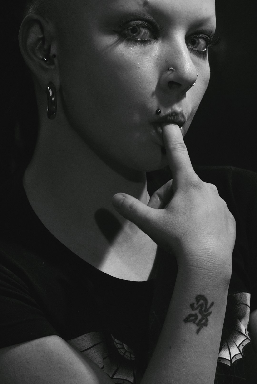 grayscale photo of woman with tattoo on her right cheek