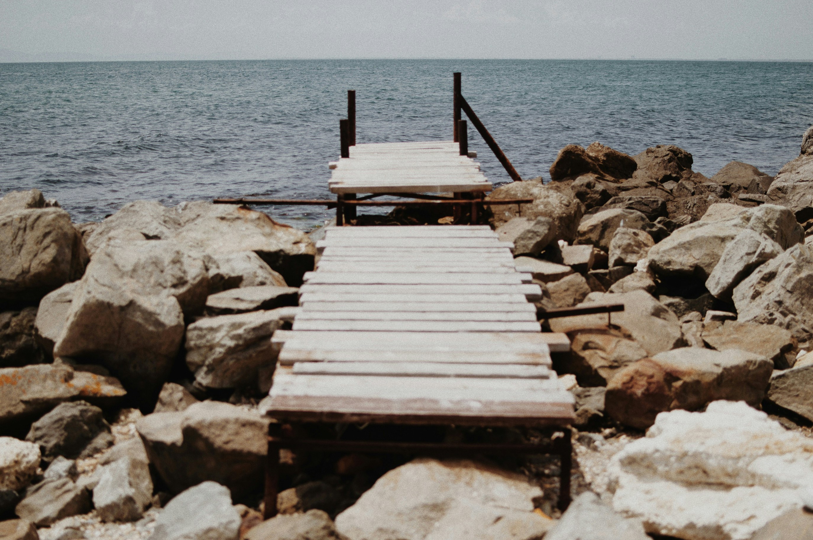 brown wooden dock on sea during daytime
