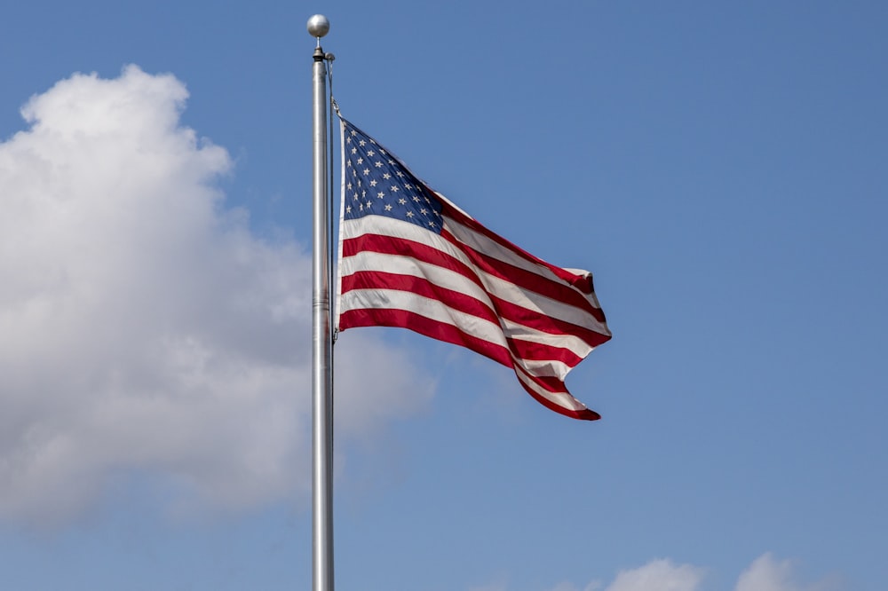 us a flag on pole during daytime