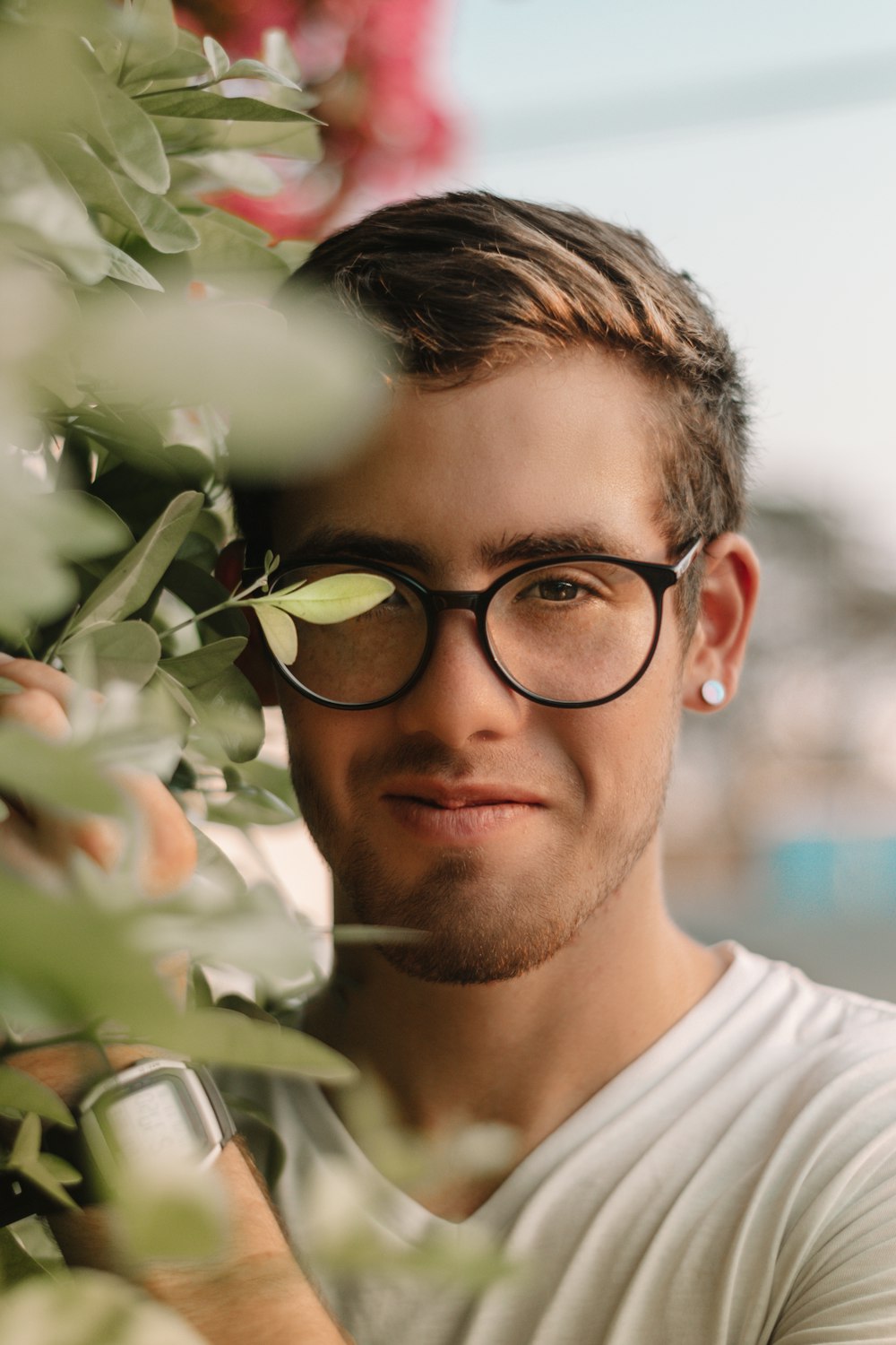 man in white crew neck shirt wearing black framed eyeglasses