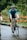man in blue crew neck t-shirt riding black bicycle on road during daytime