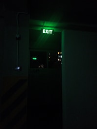 a exit sign lit up in the dark