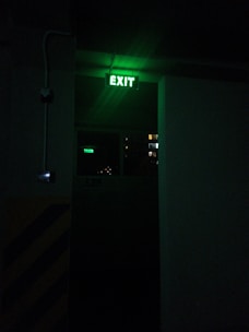 a exit sign lit up in the dark