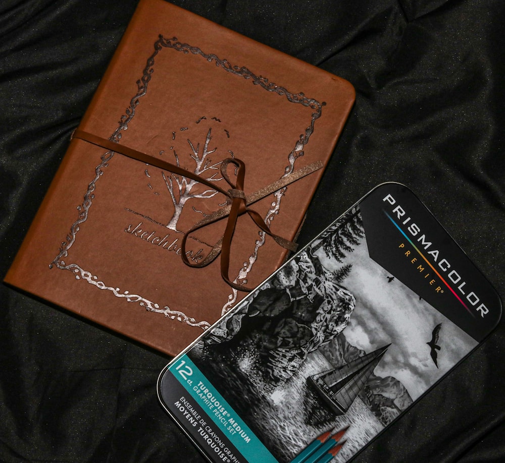 brown and black book on black textile
