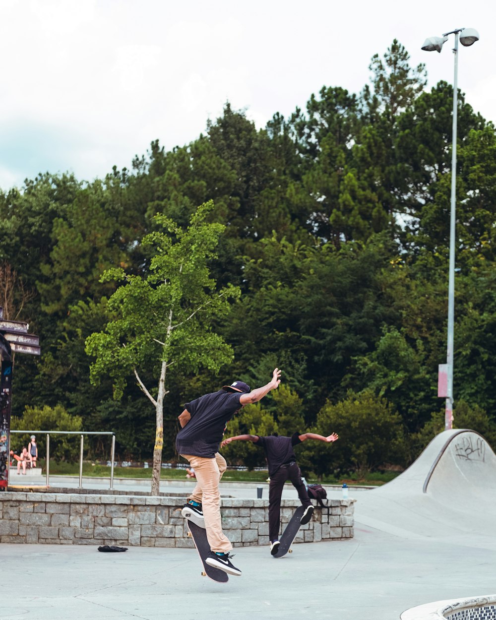 man in black t-shirt and black shorts jumping on trampoline