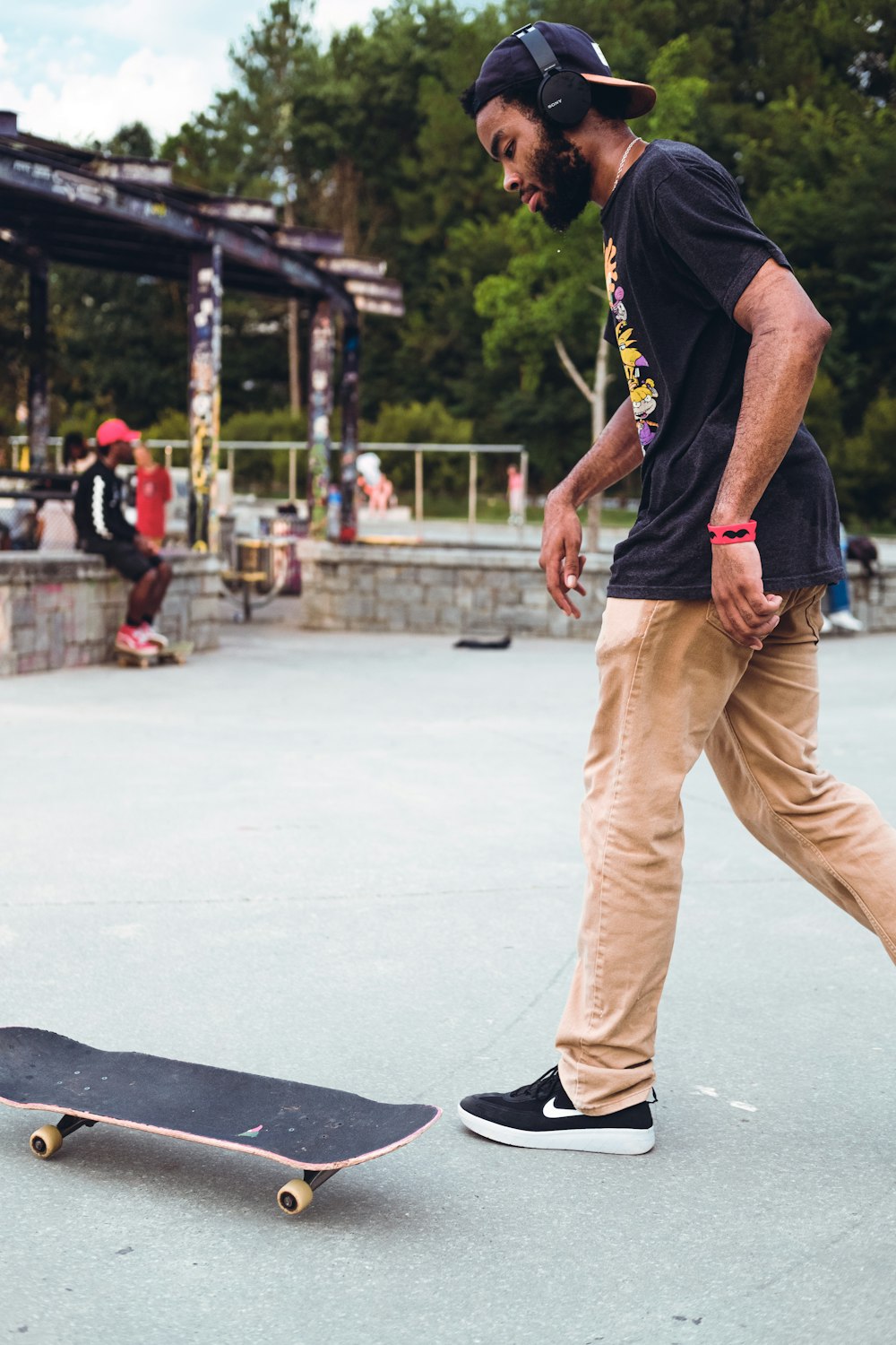 a man is walking next to a skateboard
