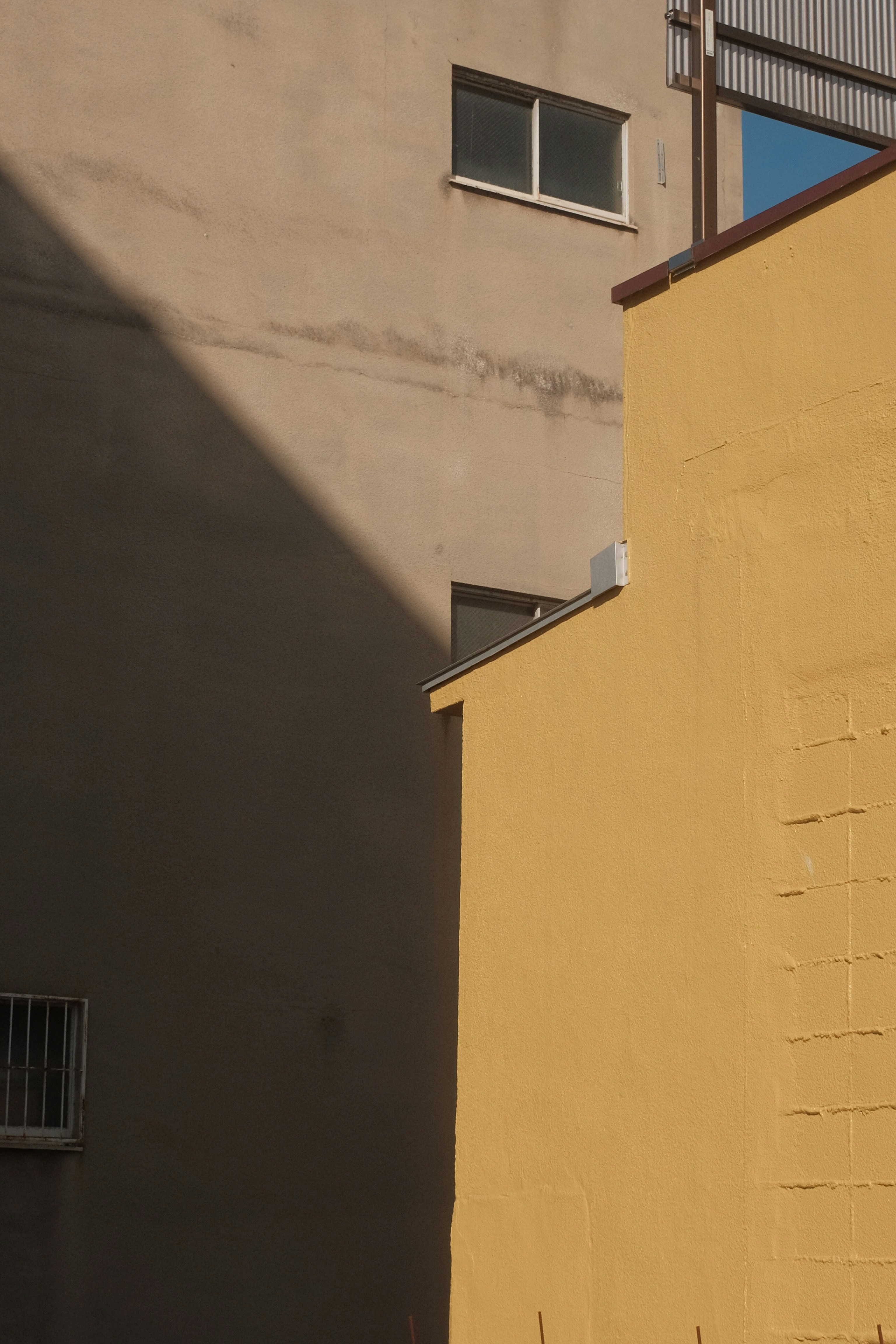 yellow concrete wall during daytime