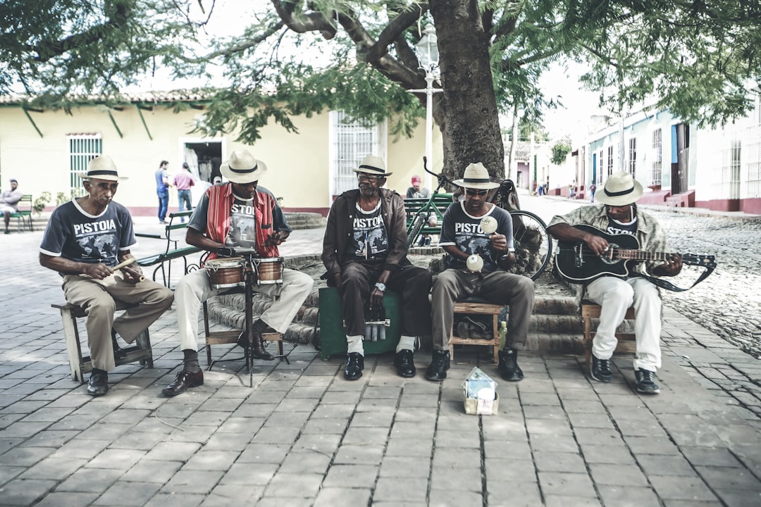 people sitting on brown wooden bench during daytime