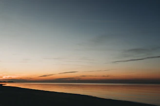 A serene horizon blending soft blues and warm hues, evoking timeless continuity.