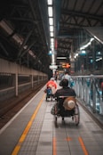 a man in a wheel chair on a subway platform