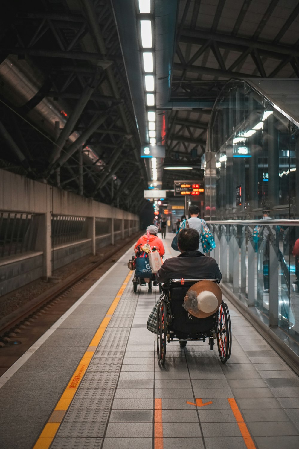 a man in a wheel chair on a subway platform