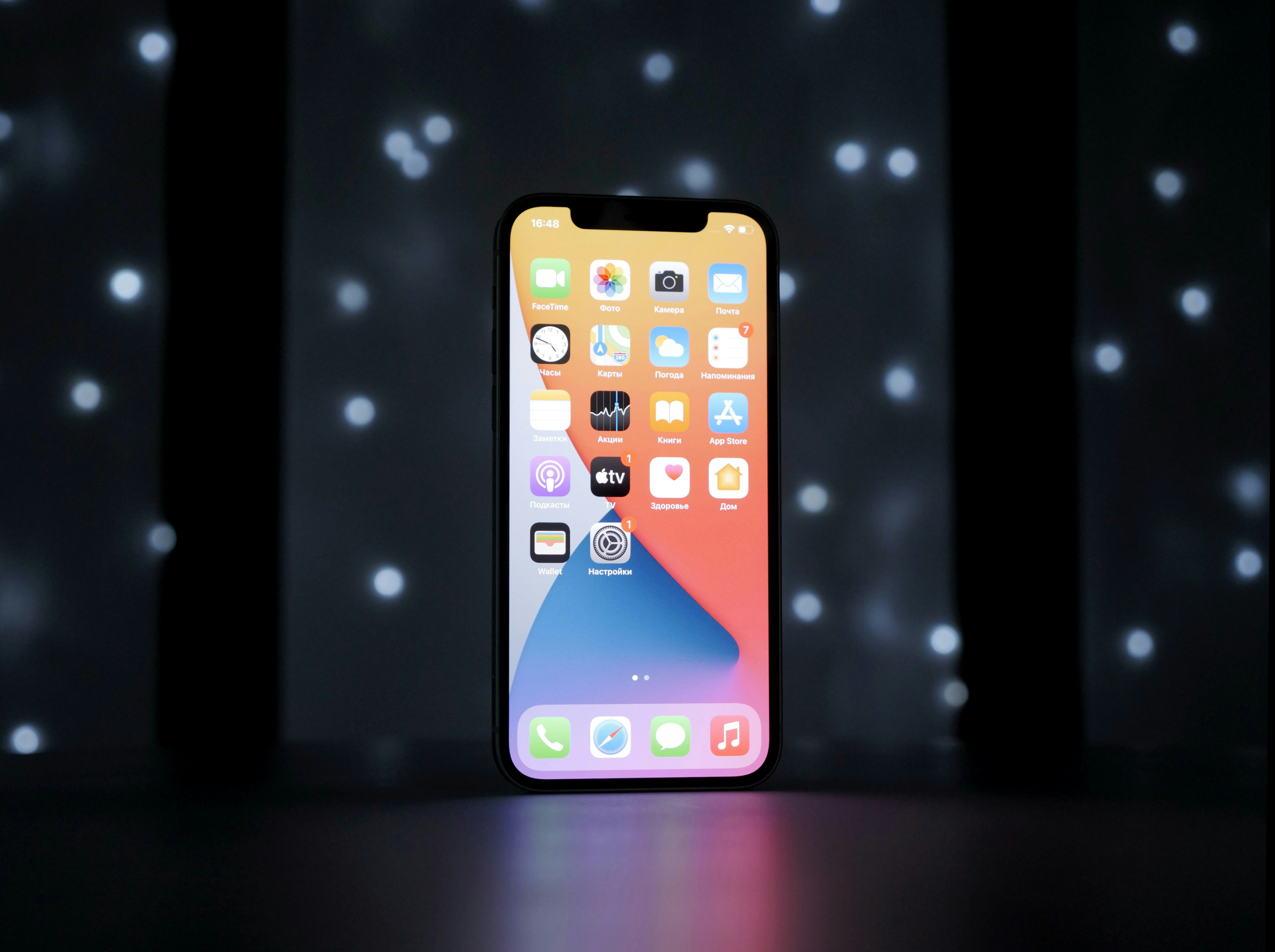 First generation Apple iPhone displaying home screen with iconic app icons on black background