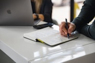 person writing on white paper