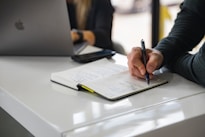person writing on white paper