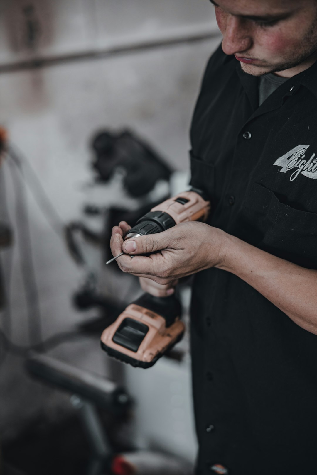 person in black shirt holding orange and black digital device