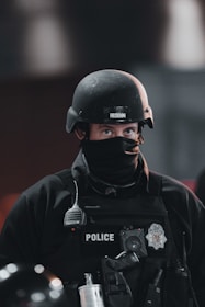 A police officer happily browsing uniform options on a sleek black and red themed online store.