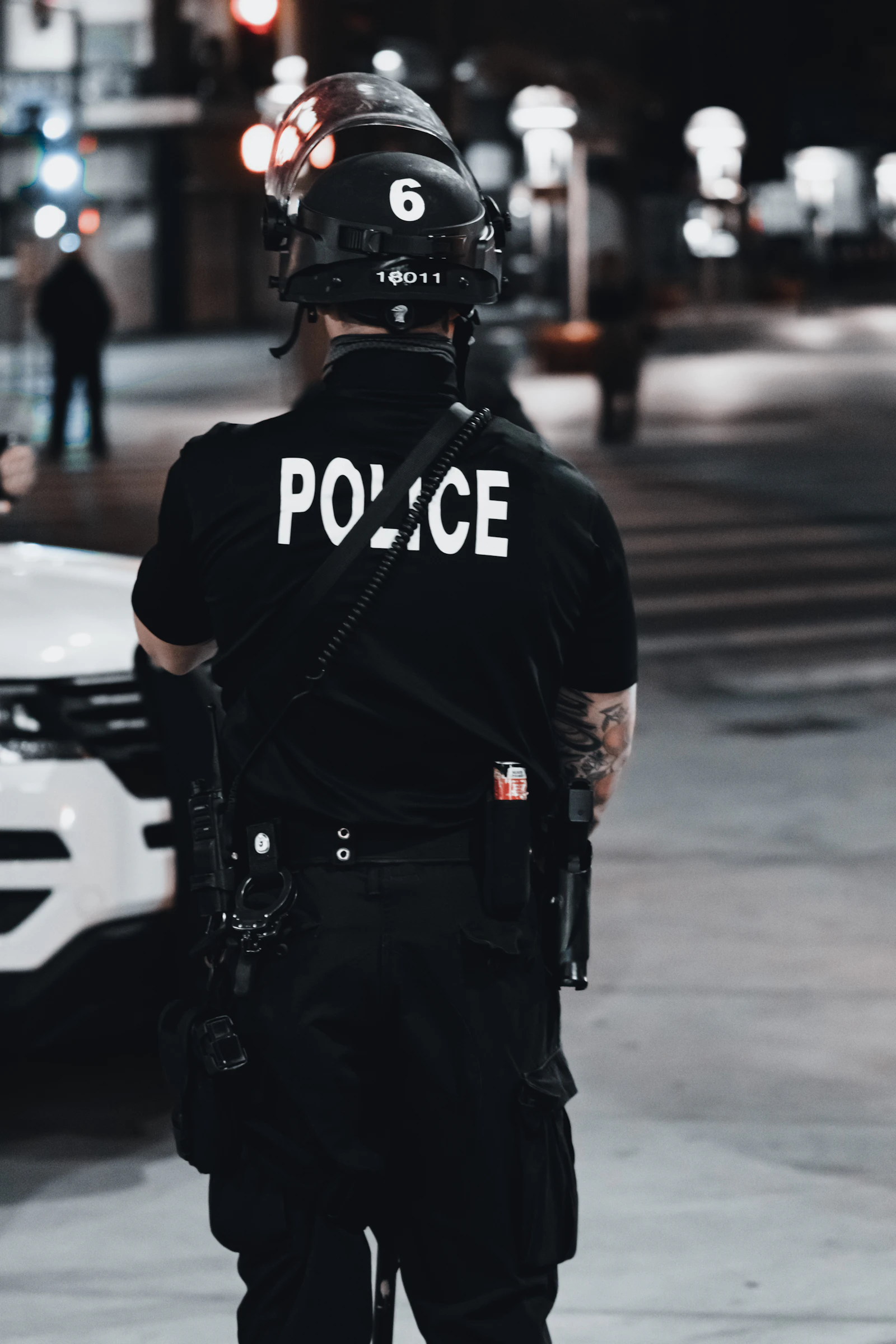 Uniformed security officer walking the perimeter of a commercial property at night