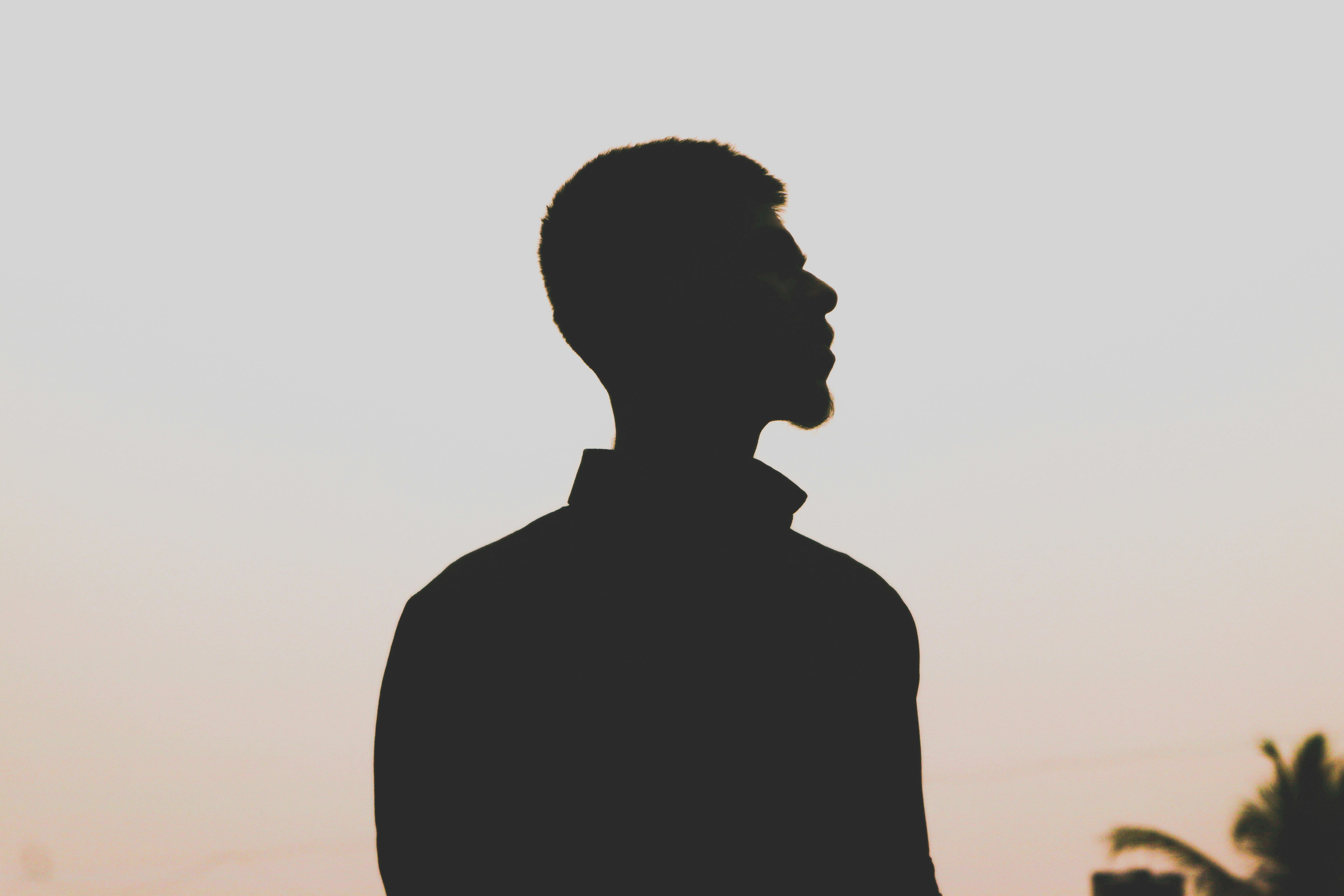 silhouette of man standing during sunset