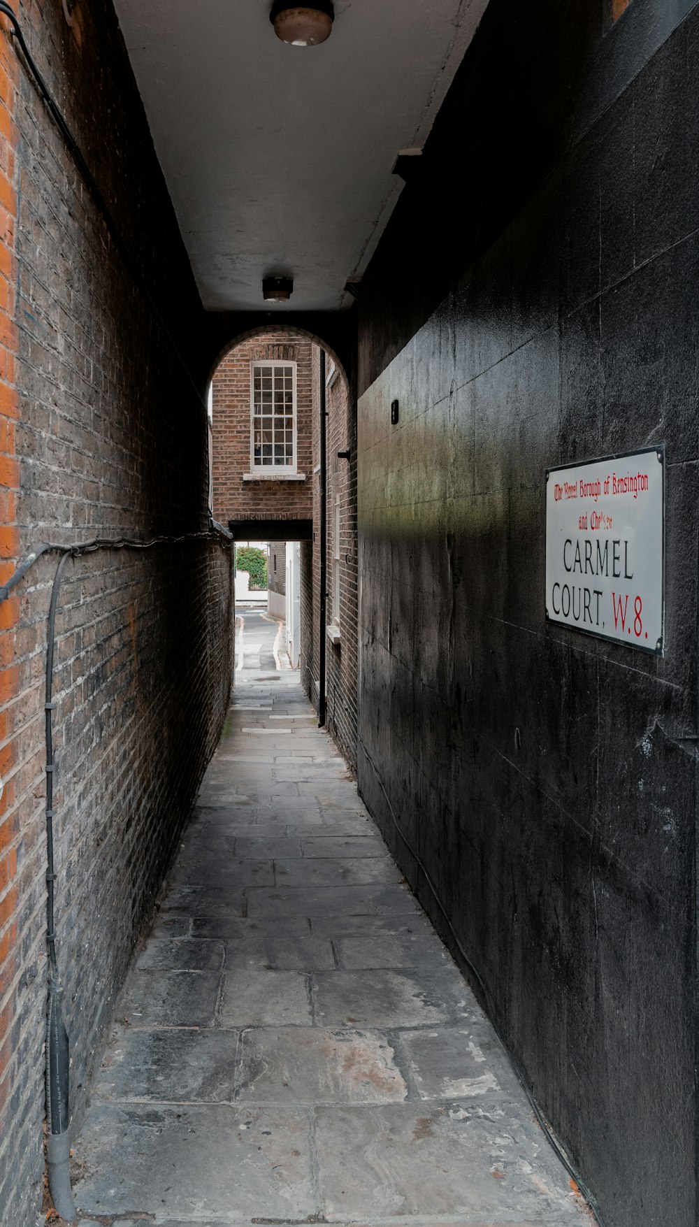 brown brick wall with no parking sign