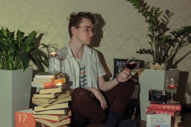 A cozy reading nook with a glass of red wine and an open notebook filled with tasting notes.