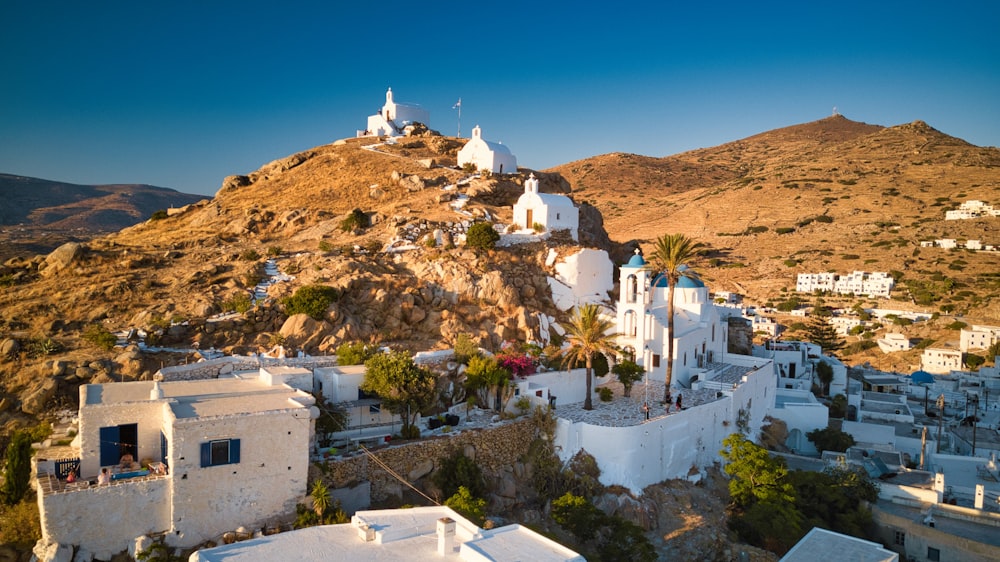 white concrete building near mountain under blue sky during daytime