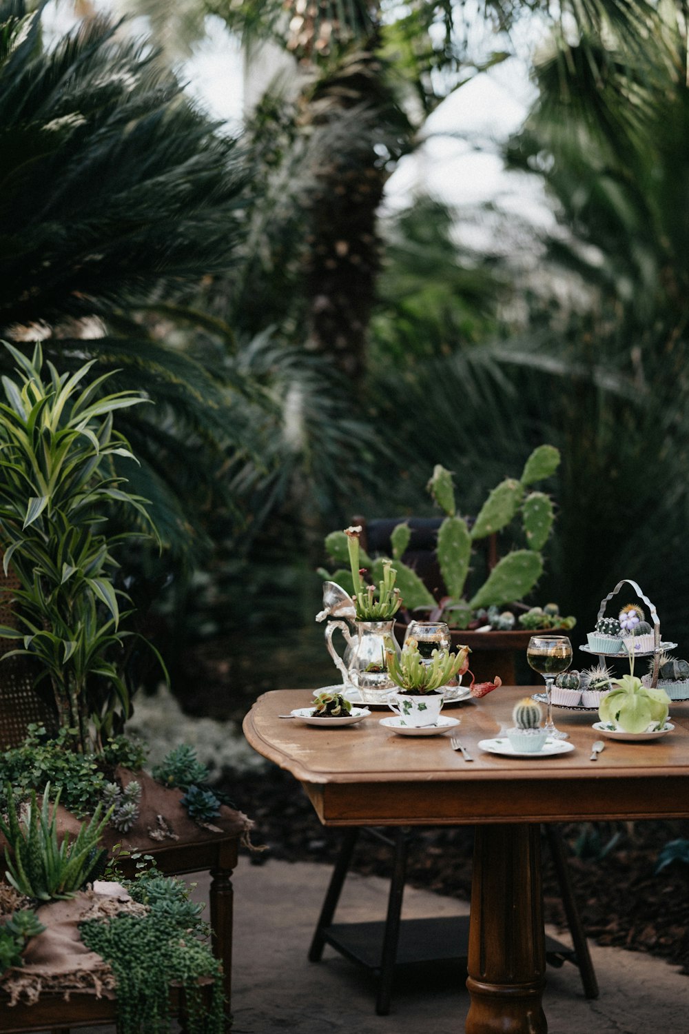 green and white ceramic mugs on brown wooden table