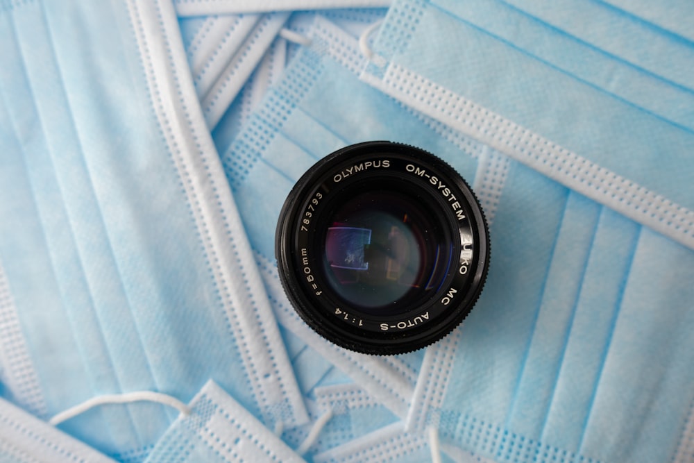 black camera lens on white and blue textile