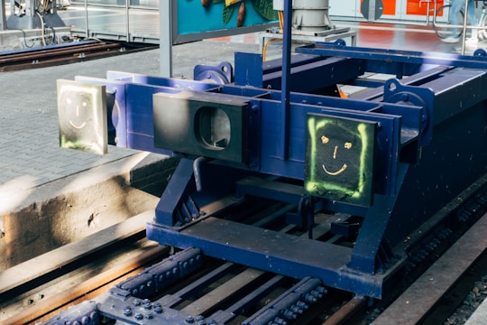 A smiling metal washbasin character sliding along neon-lit cosmic tracks filled with sparkling star drops.