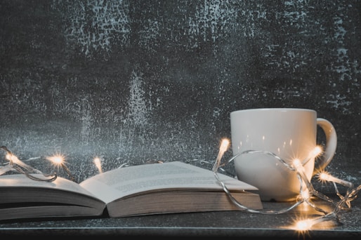 white ceramic mug on book page