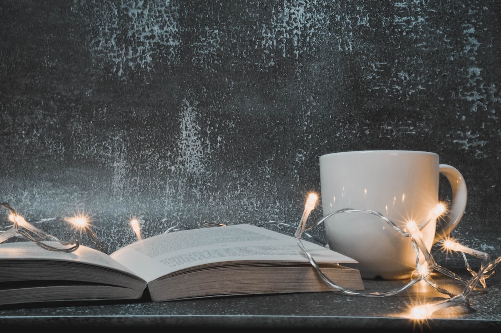 white ceramic mug on book page