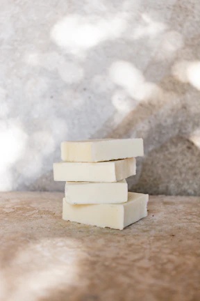 Soft morning light illuminating a stack of yaviba multani bars with fresh flowers nearby.