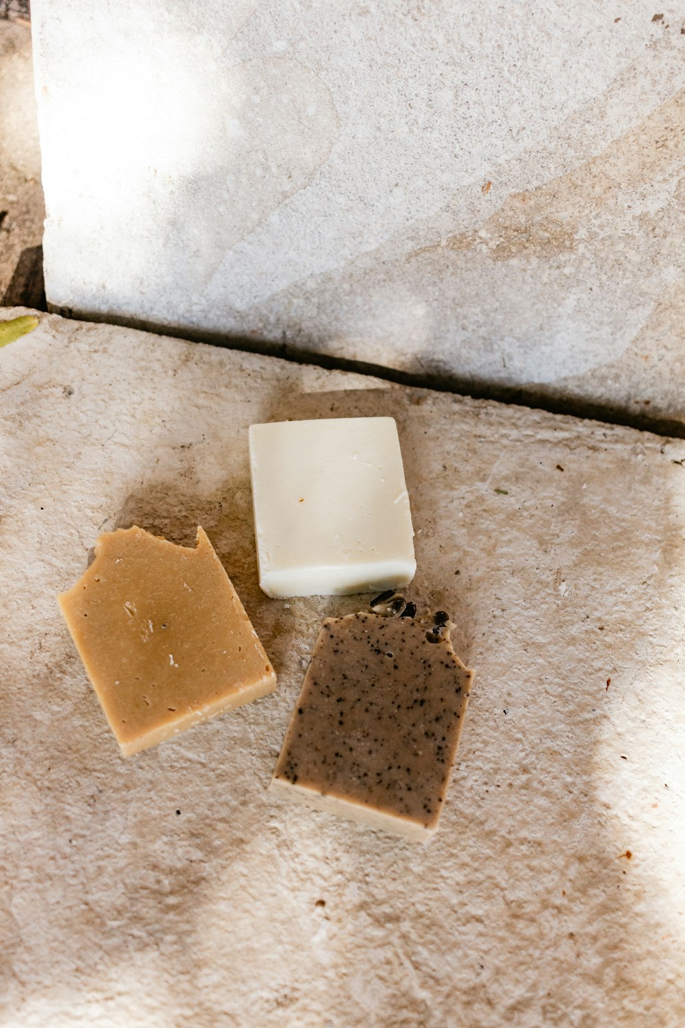 white square soap on brown concrete surface