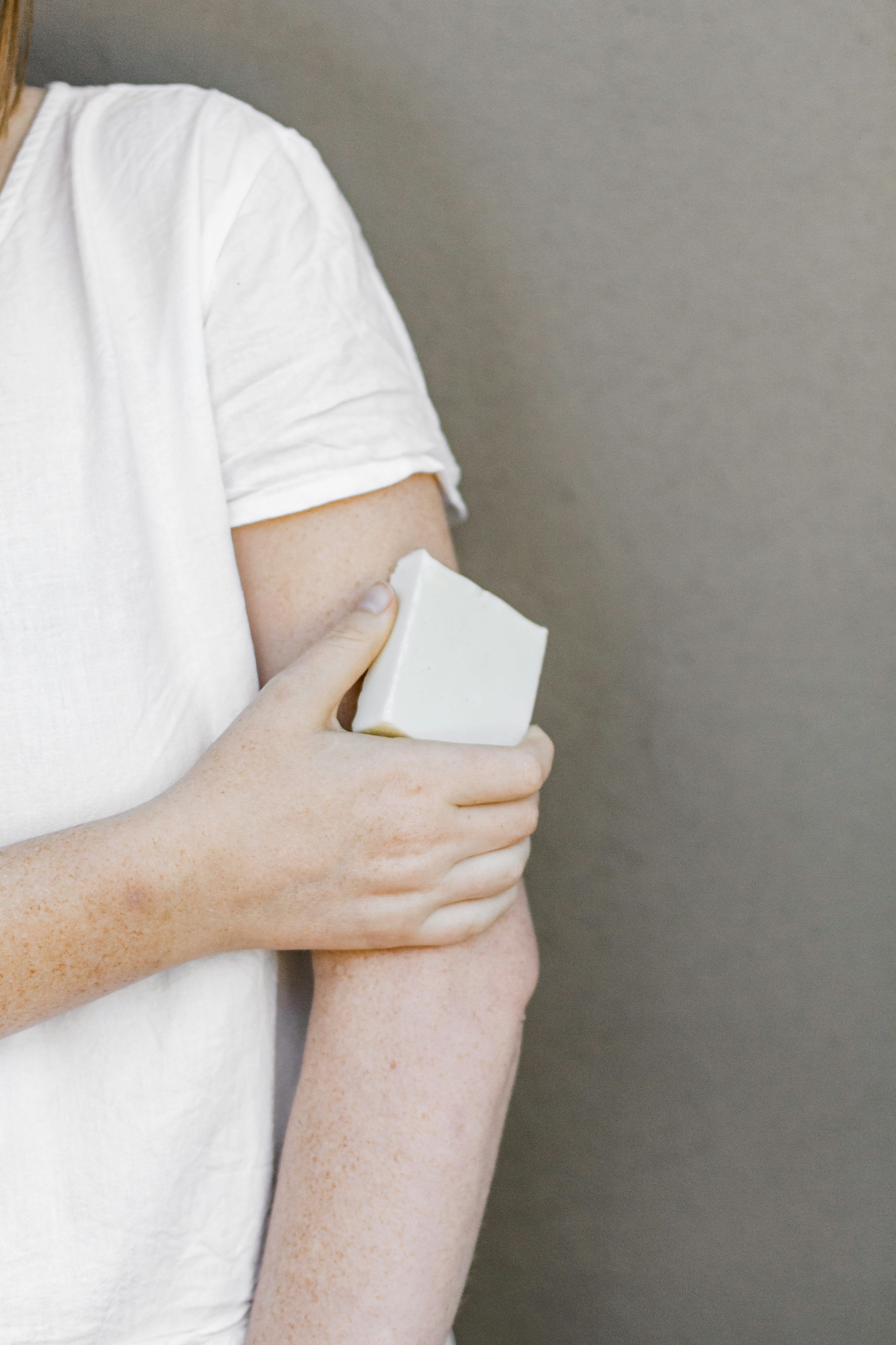 person in white t-shirt holding white box