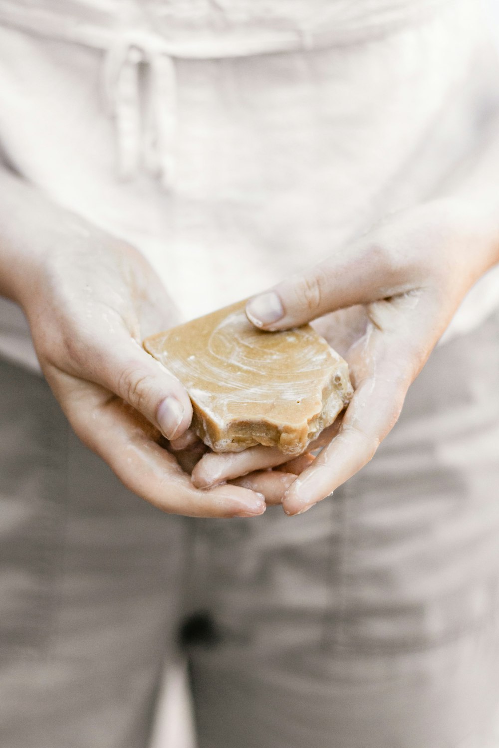 person holding brown stone fragment